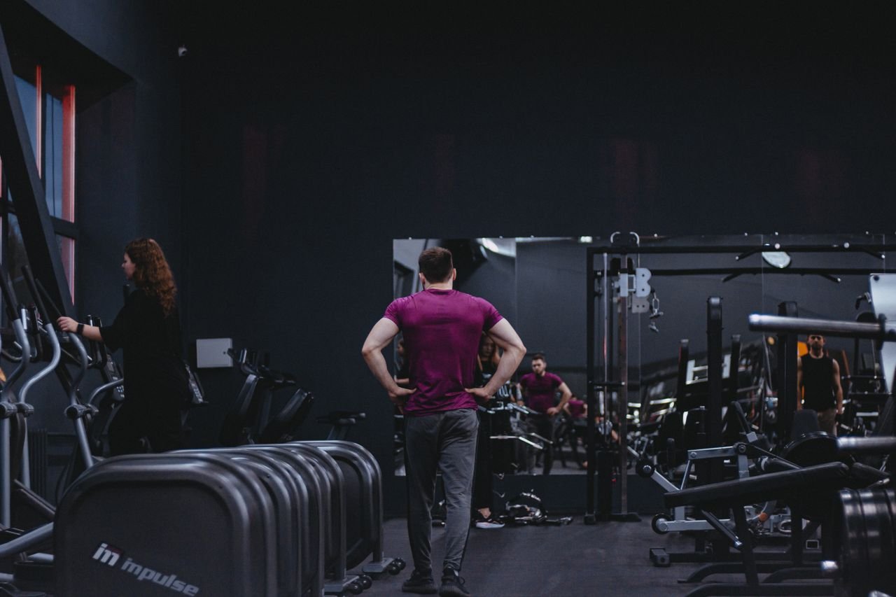 Home Man in a gym with fitness equipment, highlighting a healthy lifestyle.