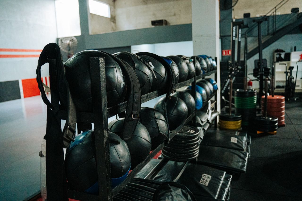 Home Well-equipped indoor gym featuring kettlebells, weights, and workout gear, perfect for fitness enthusiasts.